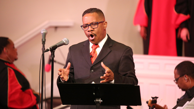 Reverend Dr. Raymond Wise leading the chorus. Image taken by Mia Beach.